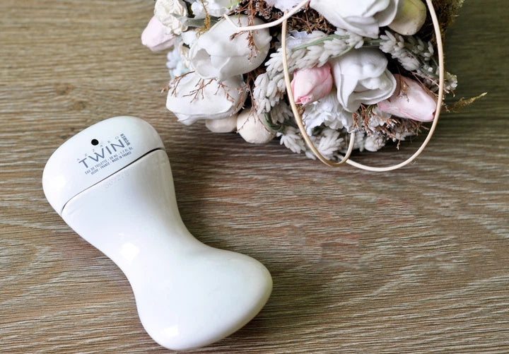 TWIN electric facial massager device on wooden background (beauty skincare tool)
