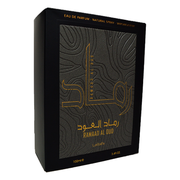 Lattafa Ramaad Al Oud EDP 100ml black perfume bottle and box with gold details on white background

